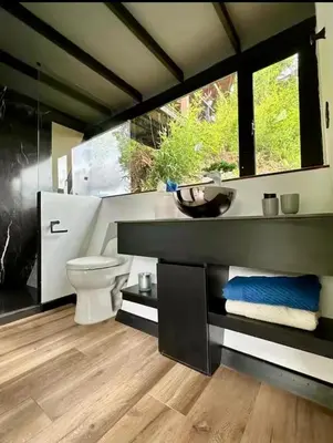 a bathroom with a toilet and a sink at Cabañas - 5 Continentes Cerca Metrocable ARVI in Guarne