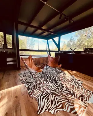 a zebra print rug on the floor of a room at Cabañas - 5 Continentes Cerca Metrocable ARVI in Guarne
