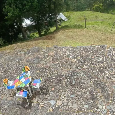 two chairs sitting on top of a rocky ground at Cabañas - 5 Continentes Cerca Metrocable ARVI in Guarne