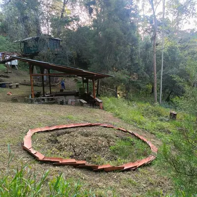 a brick circle on the ground in a field at Cabañas - 5 Continentes Cerca Metrocable ARVI in Guarne