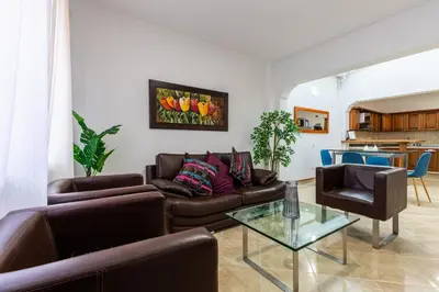 a living room with a couch and a glass table at Stay in the most welcoming place in Medellín
