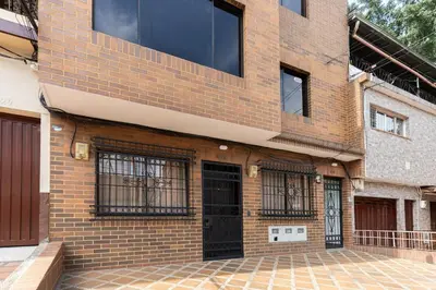 a brick building with black doors and windows at Stay in the most welcoming place in Medellín