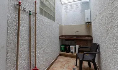 a hallway with a sink and a chair in a room at Stay in the most welcoming place in Medellín