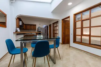 a kitchen with blue chairs and a dining table at Stay in the most welcoming place in Medellín