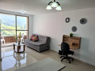 a living room with a couch and a chair at Selvatica 1014 in Sabaneta