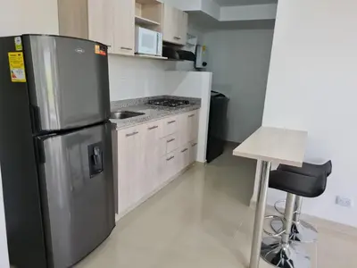 a kitchen with a stainless steel refrigerator and a stool at Selvatica 1014 in Sabaneta