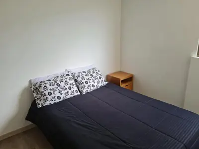 a bedroom with a blue bed with two pillows at Selvatica 1014 in Sabaneta
