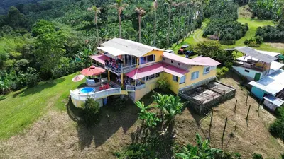 an overhead view of a large house with pink roofs at Mirador La Fortuna in San JosÃ©