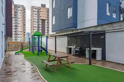 a playground on the roof of a building with a bench at Apartasuite Sabaneta City view parking in Sabaneta