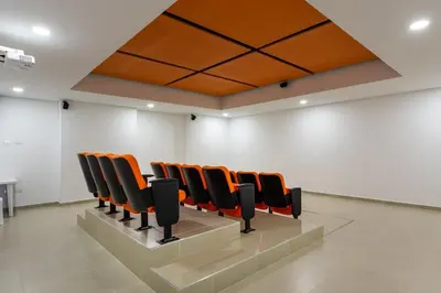 a row of chairs in a room with white walls at Apartasuite Sabaneta City view parking in Sabaneta