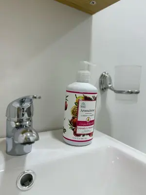 a bottle of medicine sitting on a bathroom sink at Casa Bendita - Aparta estudio 104 in Medellín