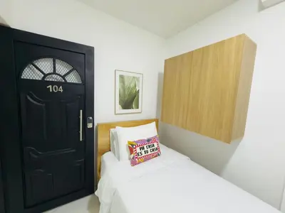 a bedroom with a black door and a bed at Casa Bendita - Aparta estudio 104 in Medellín