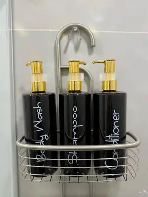 two black injector bottles on a rack in a bathroom at Casa Bendita - Aparta estudio 104 in Medellín