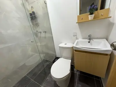 a bathroom with a toilet and a sink and a shower at Casa Bendita - Aparta estudio 104 in Medellín