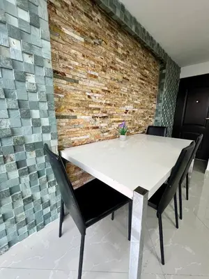 a table and chairs in a room with a brick wall at Magnificent apartment near Lleras and Provenza in Medellín
