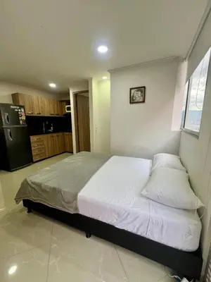a bedroom with a large bed with white sheets and pillows at Magnificent apartment near Lleras and Provenza in Medellín
