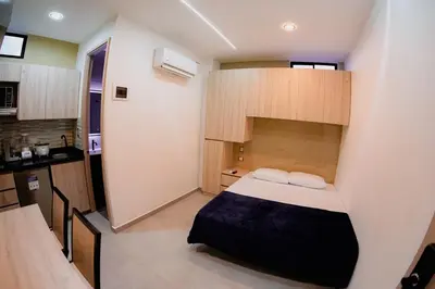 a small room with a bed and a kitchen at Live the Comuna 13 experience in Medellín INT 304 in Medellín