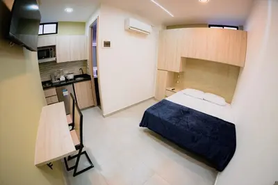 a small room with a bed and a kitchen at Live the Comuna 13 experience in Medellín INT 304 in Medellín