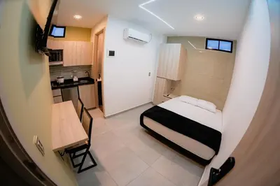 a small room with a bed and a kitchen at Live the Comuna 13 experience in Medellín INT 304 in Medellín
