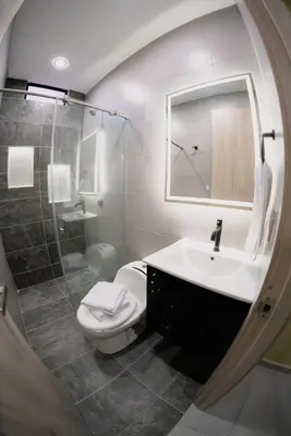 a bathroom with a toilet and a sink and a mirror at Live the Comuna 13 experience in Medellín INT 305 in Medellín