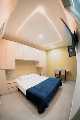 a bedroom with a large bed with a blue blanket at Live the Comuna 13 experience in Medellín INT 305 in Medellín