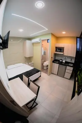 a small room with a bed and a kitchen at Experience Medellín's Comuna 13 INT401 in Medellín