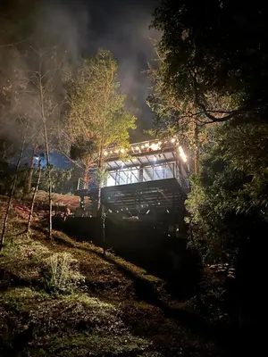 a train traveling through a forest at night at Cabaña Del Lago - Cerca Metrocable ARVI in Guarne