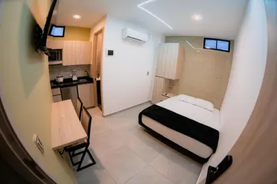 a small room with a bed and a kitchen at vive la experiencia comuna 13 Medellín INT 304 in Medellín