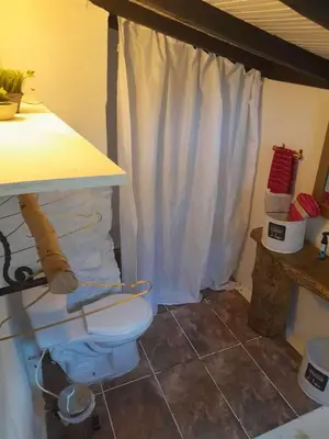 a bathroom with a white toilet in a room at Cabaña Blanca Cielo Abierto in Guarne