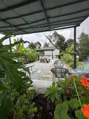 a patio with a bench and a picnic table at Cabaña Blanca Cielo Abierto in Guarne