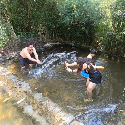 a group of people standing in the water at Cabaña en el Lago Cerca MetroCable ARVI in Guarne