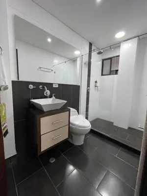 a bathroom with a toilet and a sink and a mirror at Casa Hotel Spa Carolina in Carolina del Principe