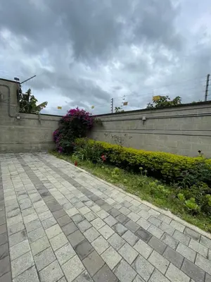 a stone wall with flowers next to a sidewalk at Casa Hotel Spa Carolina in Carolina del Principe