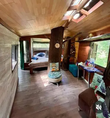 a room with a bedroom and a bed in a house at Refugio en el Árbol in Guarne