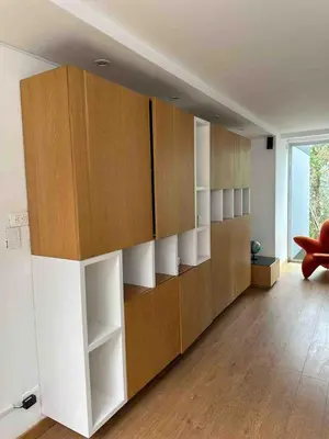 a room with a large wall of brown and white shelves at Country house near the airport and Medellin in El Retiro