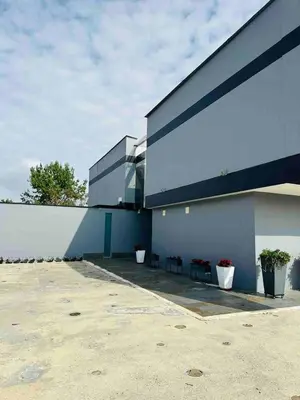 a building with three potted plants on the side of it at Country house near the airport and Medellin in El Retiro