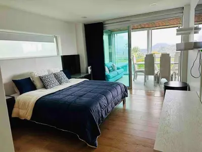 a bedroom with a large bed and a dining room at Villa near the airport and Medellin in El Retiro