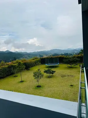 a balcony with a view of a park with trees at Villa near the airport and Medellin in El Retiro