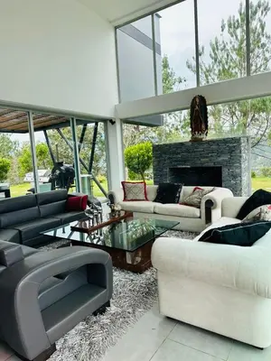 a living room with couches and a fireplace at Villa near the airport and Medellin in El Retiro