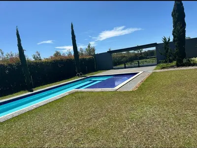 a swimming pool in a yard next to a fence at Villa near the airport and Medellin in El Retiro