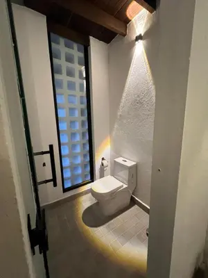 a bathroom with a toilet in a room with a window at Casa La Oronda - Hotel Boutique- Cauca Viejo in Jericó