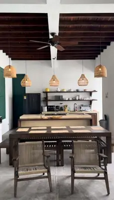 a kitchen with a large wooden table and two benches at Casa La Oronda - Hotel Boutique- Cauca Viejo in Jericó