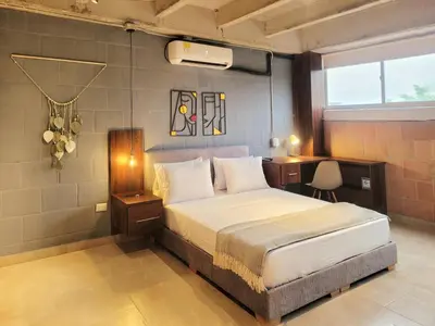 a bedroom with a bed and a desk in it at The Hub by Wynwood House in Medellín