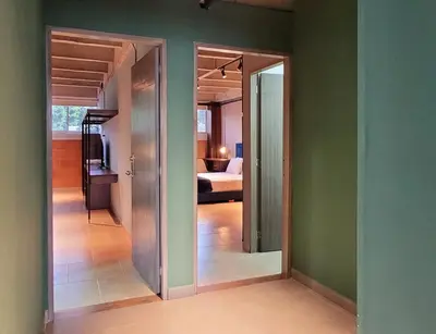 a hallway with a room with a bed and a mirror at The Hub by Wynwood House in Medellín