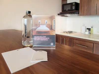 a book sitting on a table next to a bottle of wine at The Hub by Wynwood House in Medellín