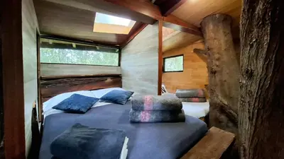 a bedroom in a tree house with a bed at Casa en el Arbol - Cerca Metrocable ARVI - Camping in Guarne