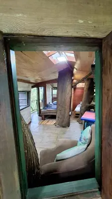 a view of a room with a couch and a table at Casa en el Arbol - Cerca Metrocable ARVI - Camping in Guarne