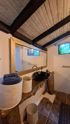 a bathroom with a sink and a counter with buckets at Cabaña Blanca Guarne cerca a Metrocable ARVI in Guarne