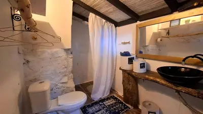 a bathroom with a white toilet and a sink at Cabaña Blanca Guarne cerca a Metrocable ARVI in Guarne