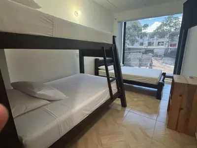 two bunk beds in a room with a window at Angel Mari a Doradal in Doradal